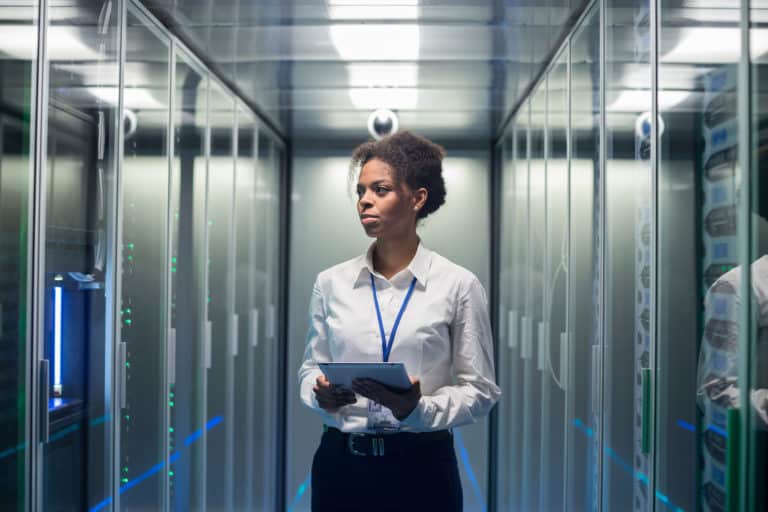 Woman with tablet diagnosing servers