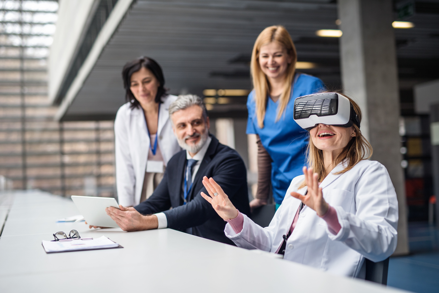 Doctors and pharmaceutical sales representative using VR goggles