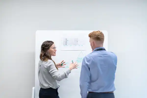 engineers discussing at a whiteboard_small