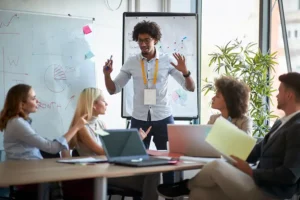 An image showing a team at a startup, discussing ideas around a table. This image accompanies GrantTree's blog on the Enhanced R&D intensive support scheme (ERIS).