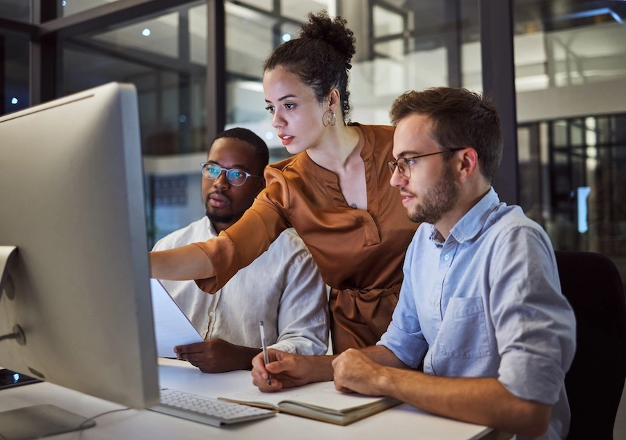 An image of three people looking at a screen - accompanying GrantTree's blog on the 2025 R&D Tax Changes