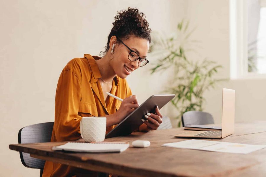 Female designer at home sketching on a digital tablet