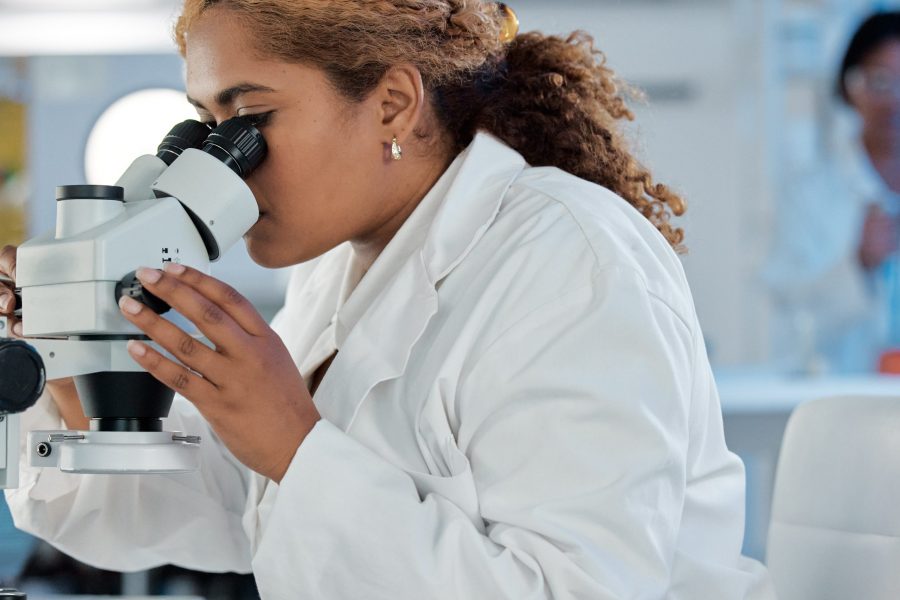 Science, development and microscope with a woman at work in a laboratory for research or innovation. Healthcare, medical and investigation with a female scientist working in a lab for pharmaceuticals.