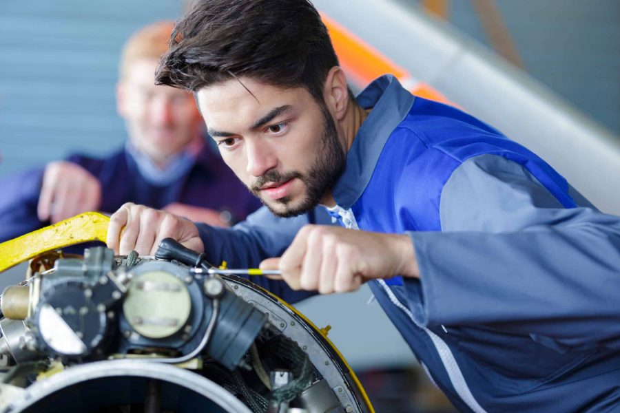 checking airplane engine in airport hangar