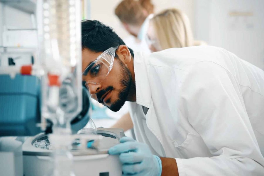 Young students of chemistry working in laboratory