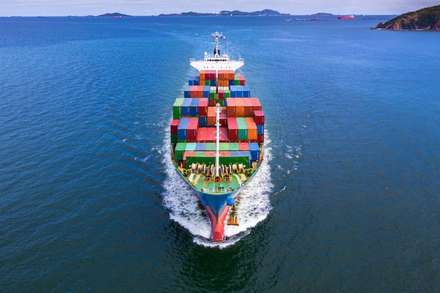 Aerial view container ship carrying container in import export business logistic and transportation of international by container ship in the open sea.