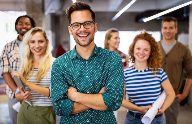 Happy business people celebrating success at company