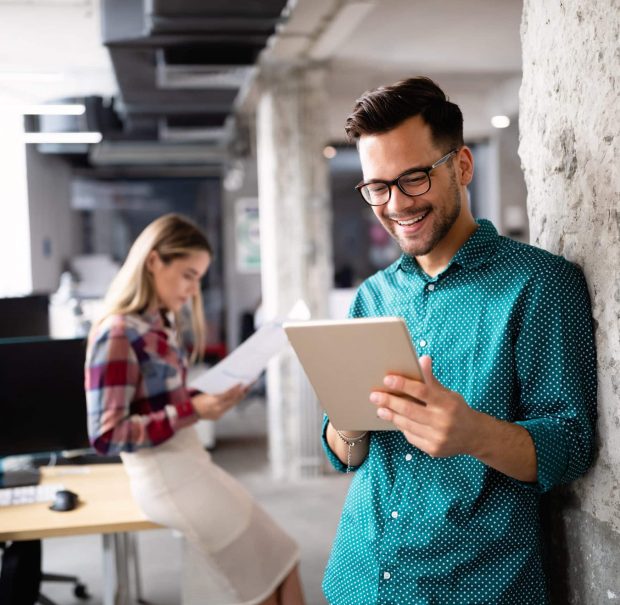 Man holding tablet - image for GrantTree's debt financing and advance funding blogs