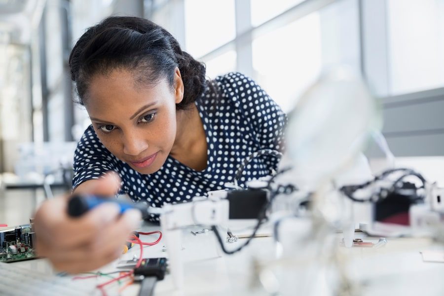 Focused engineer assembling robot